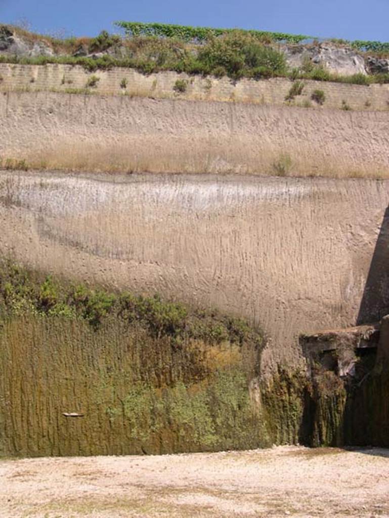 Villa dei Papiri, Herculaneum. July 2004. The remains (bottom right) of an apsidal/bow window on the second lower level. The depth and solidity of the volcanic material can be seen here.
Photo courtesy of Jennifer Stephens. ©jfsPAP0660